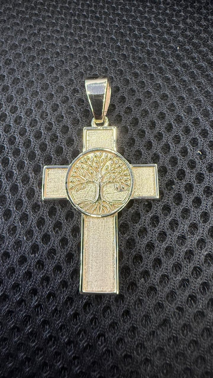 Yellow gold cross pendant with a tree of life medallion at the center